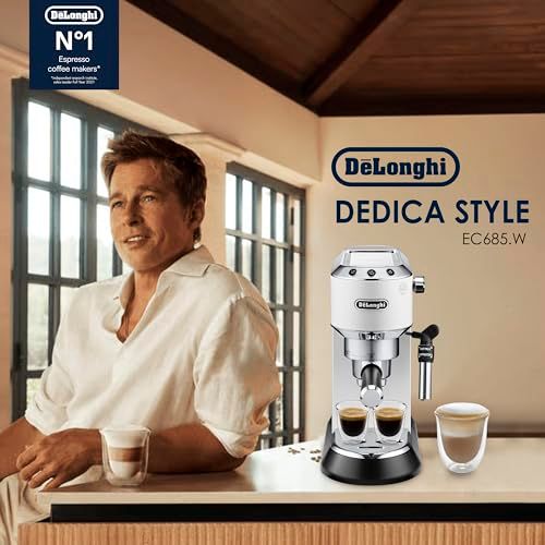 De'Longhi Dedica EC685 White espresso machine with two cups of coffee on a counter, featuring a sle…
