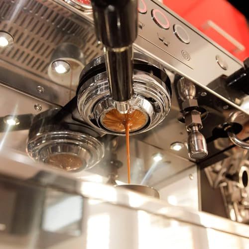 Julius Meinl Espresso Arabica 1kg coffee beans, rich brown espresso pouring from a shiny espresso m…