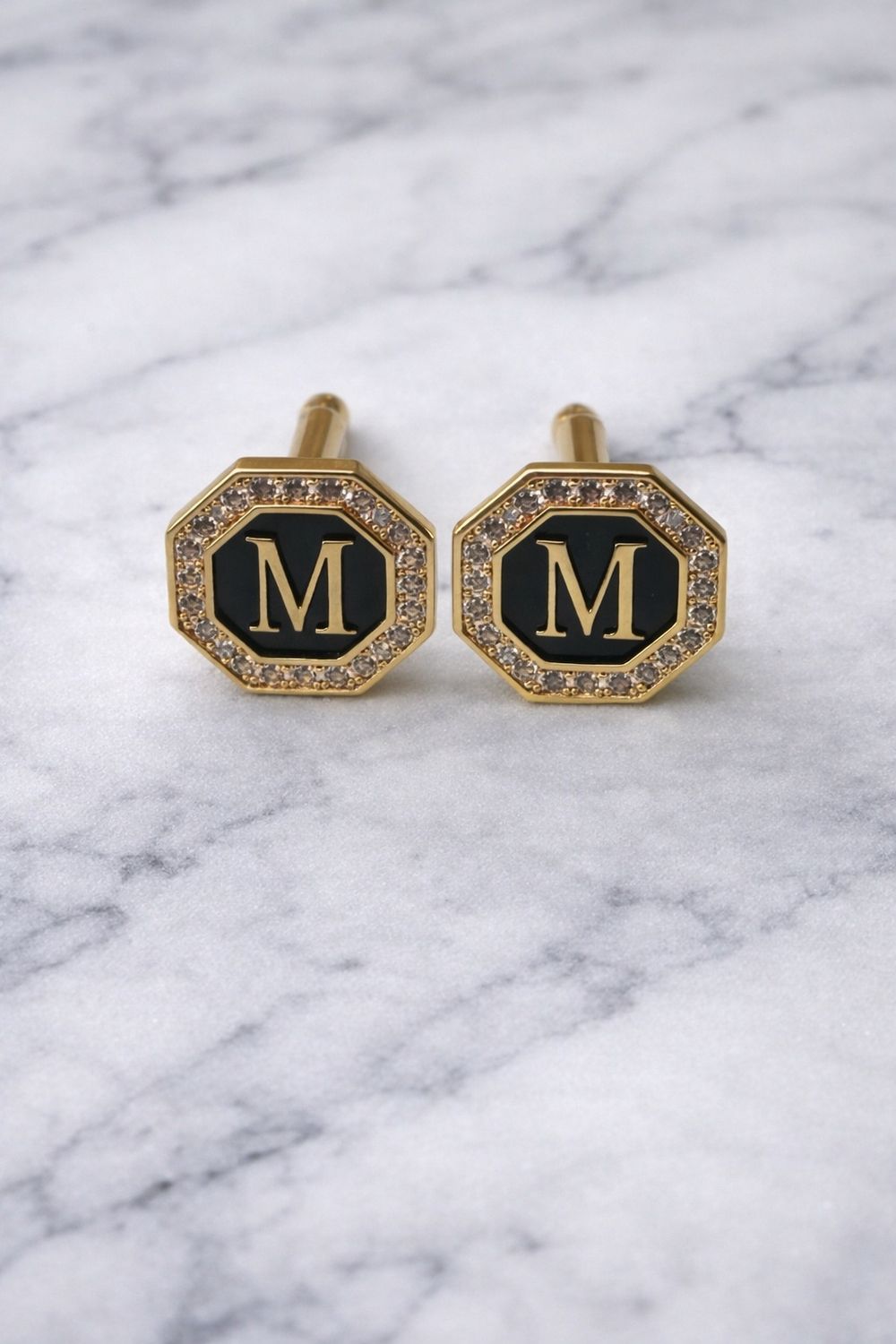 Golden in color initial cufflinks M