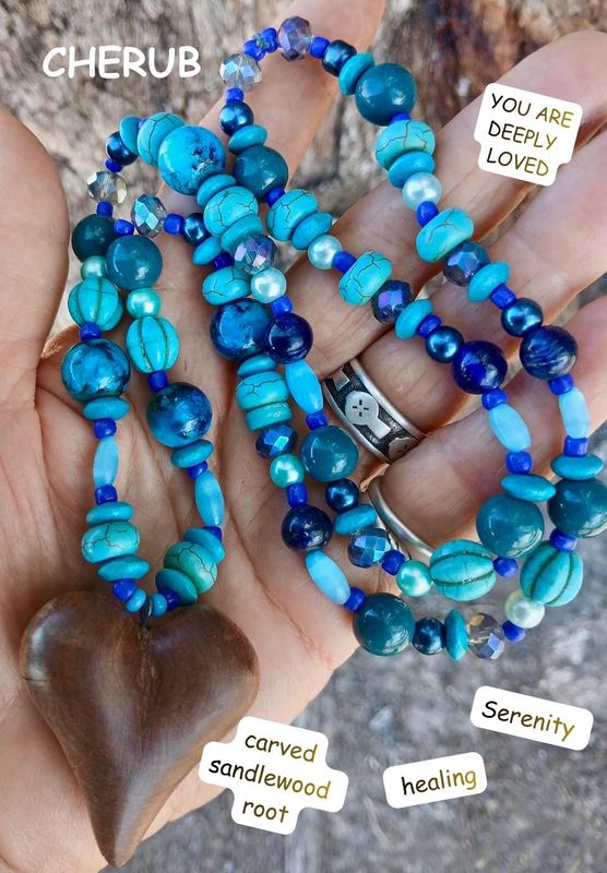 CHERUB- Beautiful, UNIQUE carved heart from Sandalwood root with Ulysees coloured beads SERENITY and LOVE- everywhere. Watch out! and play. Cherub is about fun