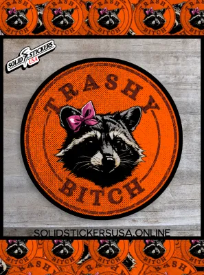Orange and Black vinyl sticker with the Trashy Bitch Raccoon design on a wooden surface.