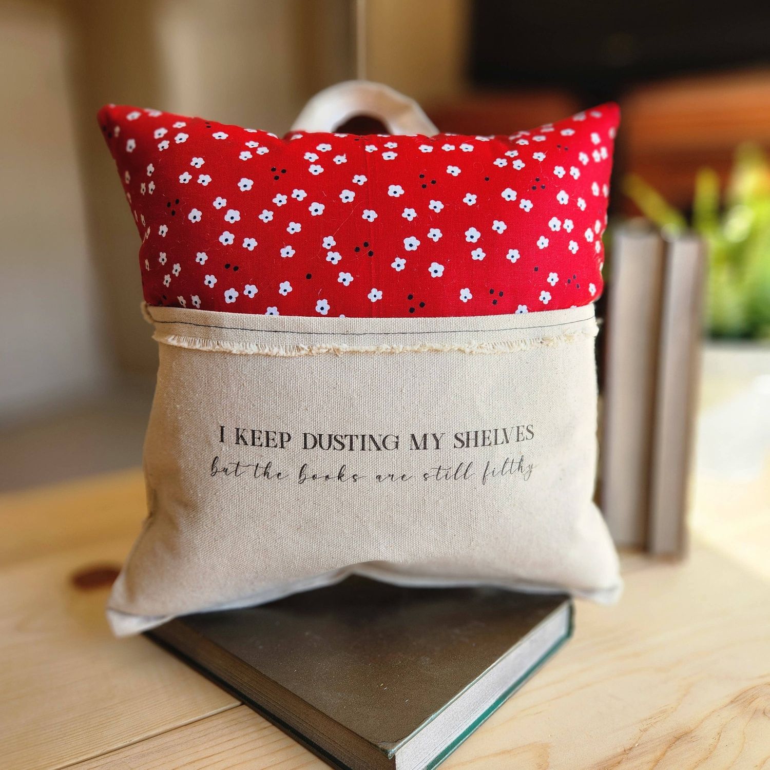 I Keep Dusting..., Reading Pillow, red with white flower