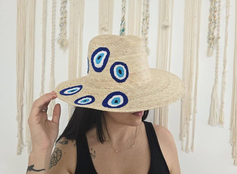 Embroidered  straw hat with embroidered evil eye decoration