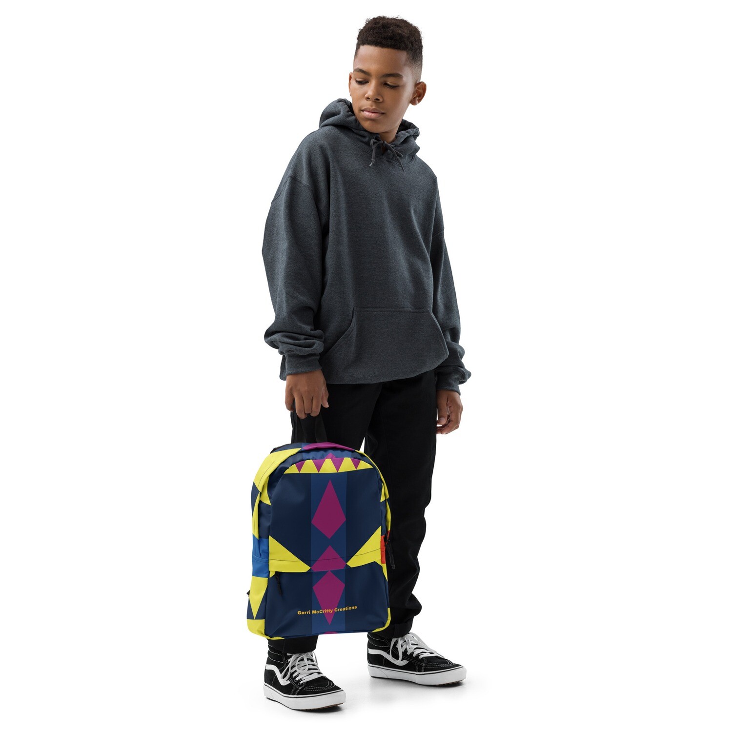 Yellow, maroon &amp; blue geometric shapes cover this backpack.
