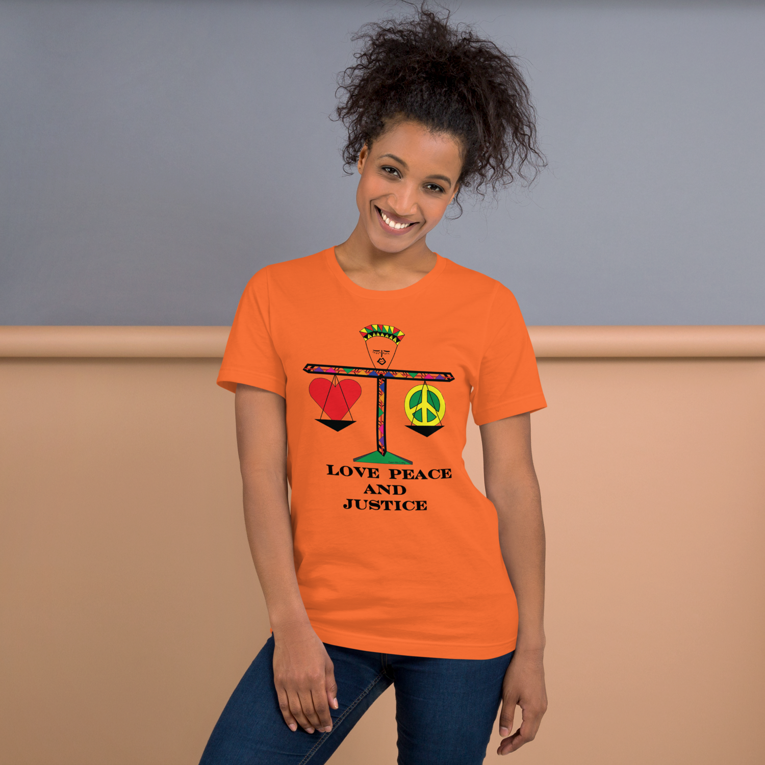 A figure balancing a heart &amp; a peace sign on choice of t-shirt colors