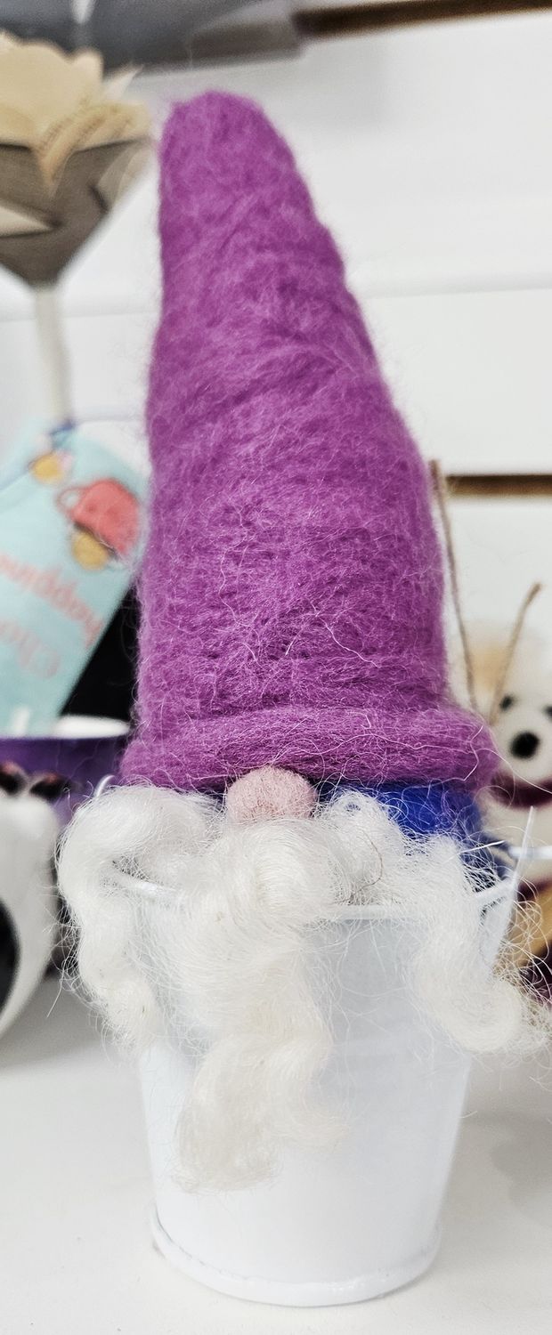 Gnome in a bucket with purple hat