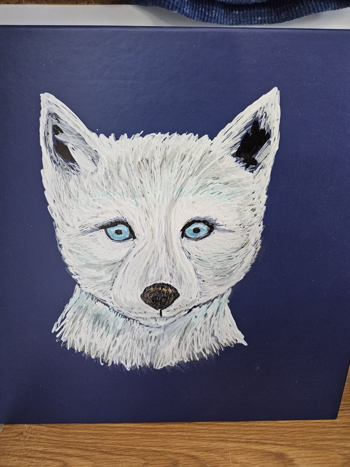 Painted Arctic wolf cub on box