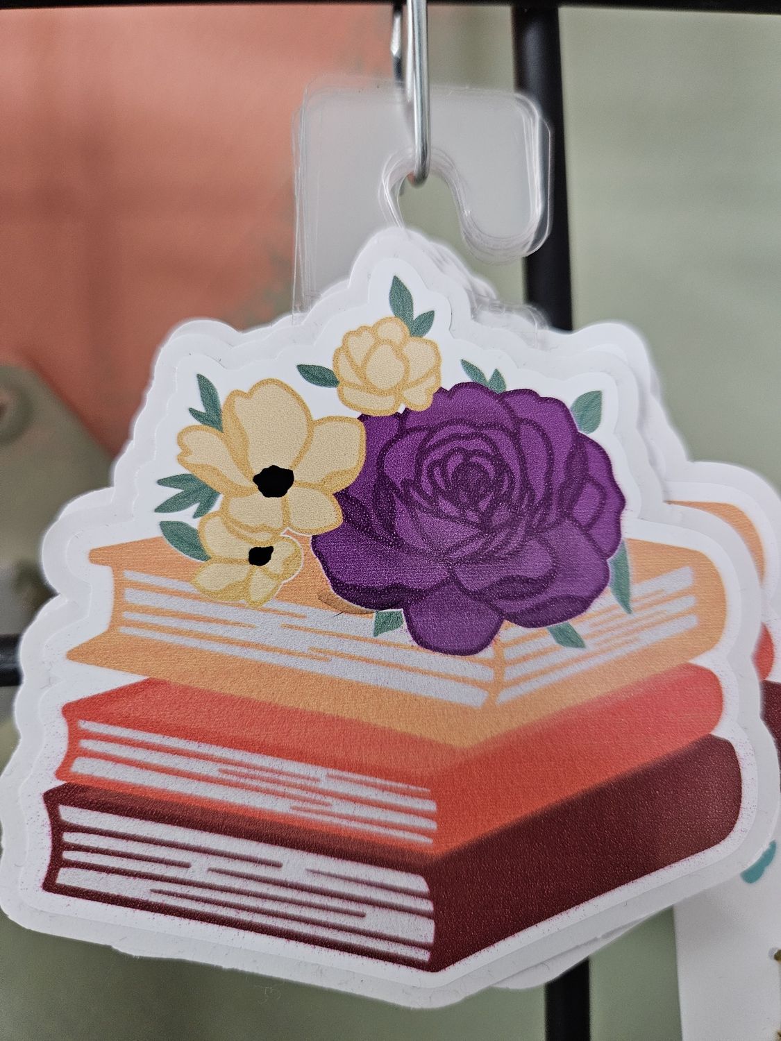 Pile of books with flowers sitcker