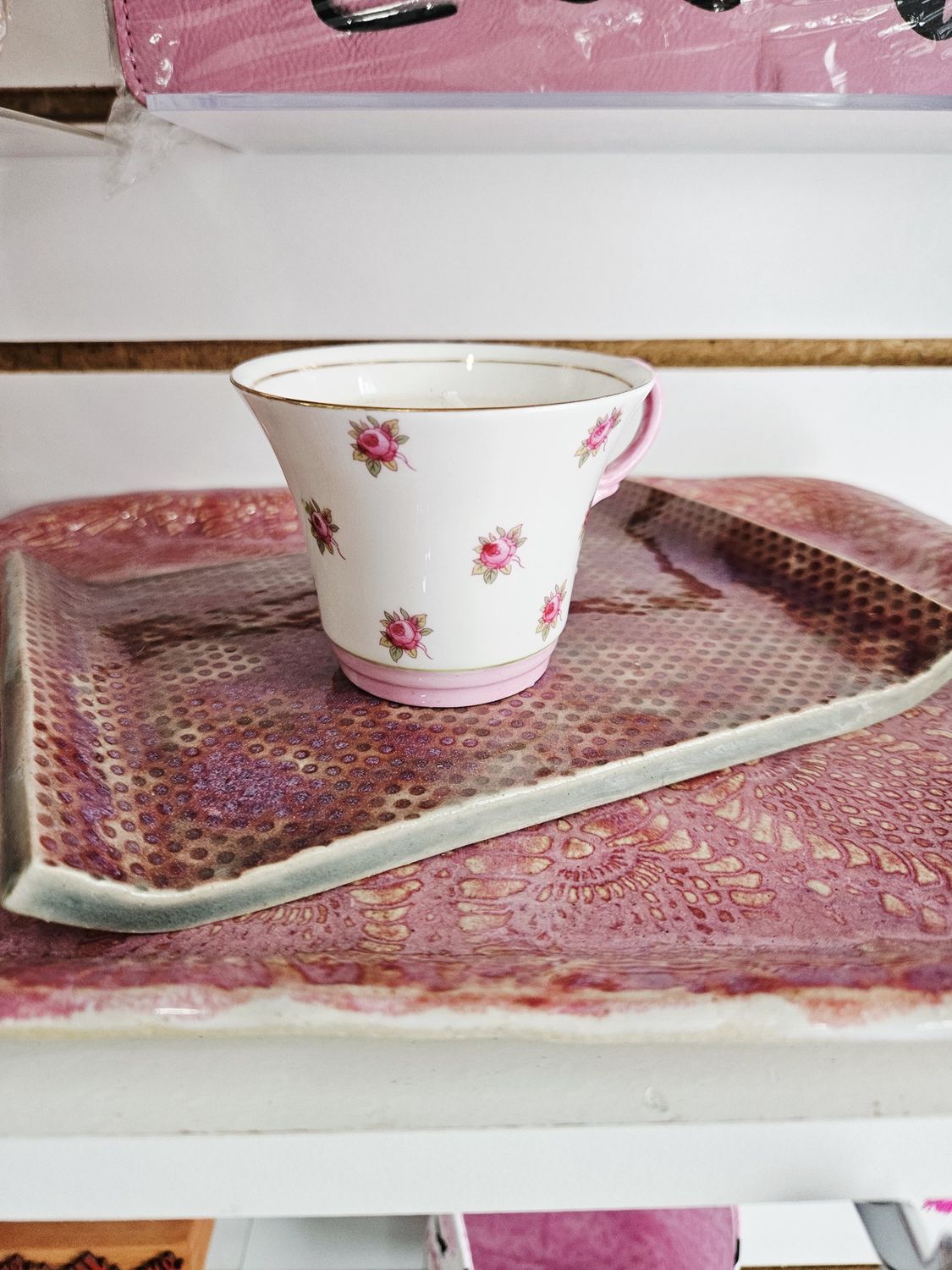 White teacup with pink flowers candle