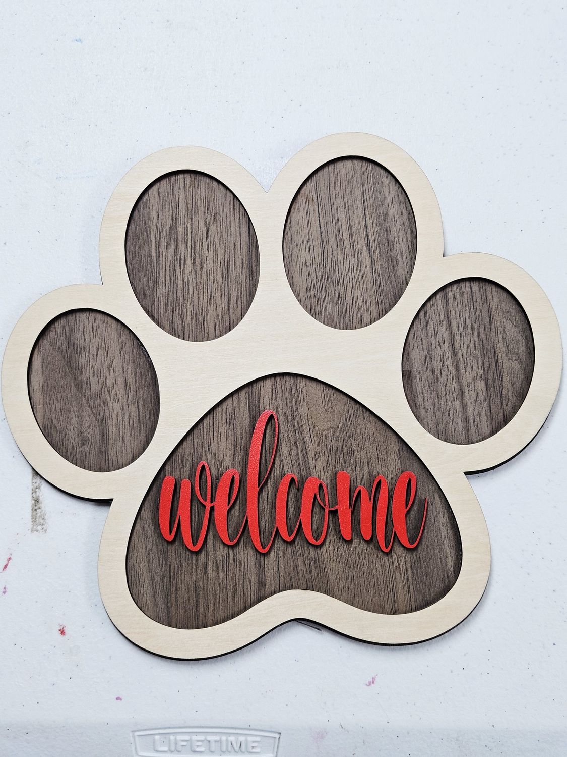 Paw print welcome sign red
