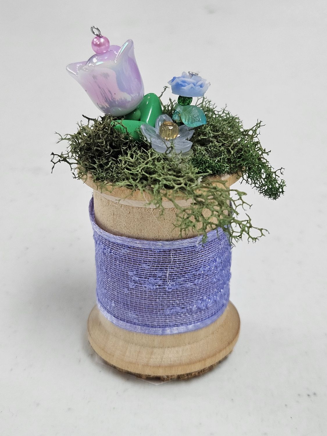 Purple Beaded Flowers in wooden spool