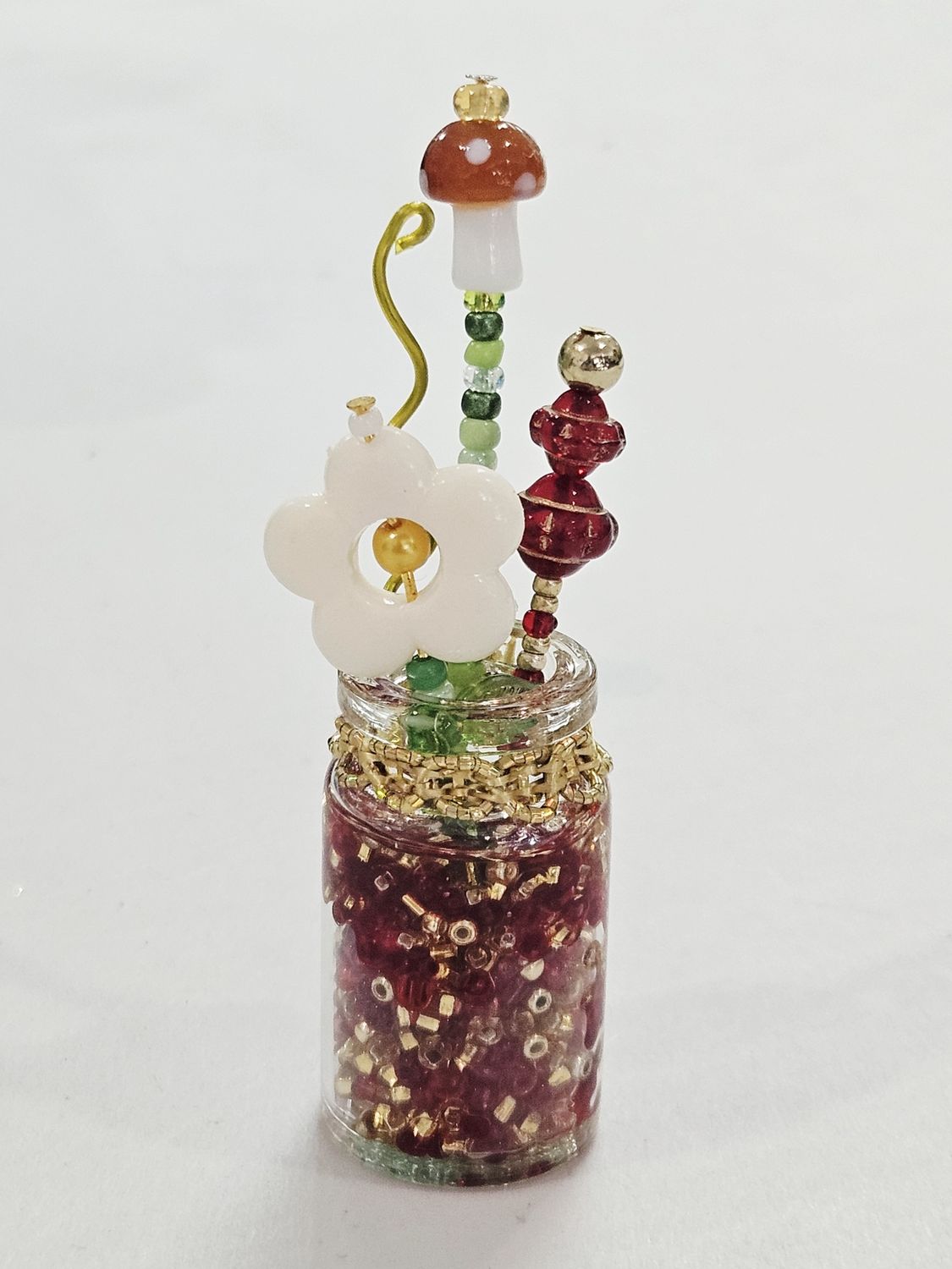 Red and Gold beaded flowers in clear vase