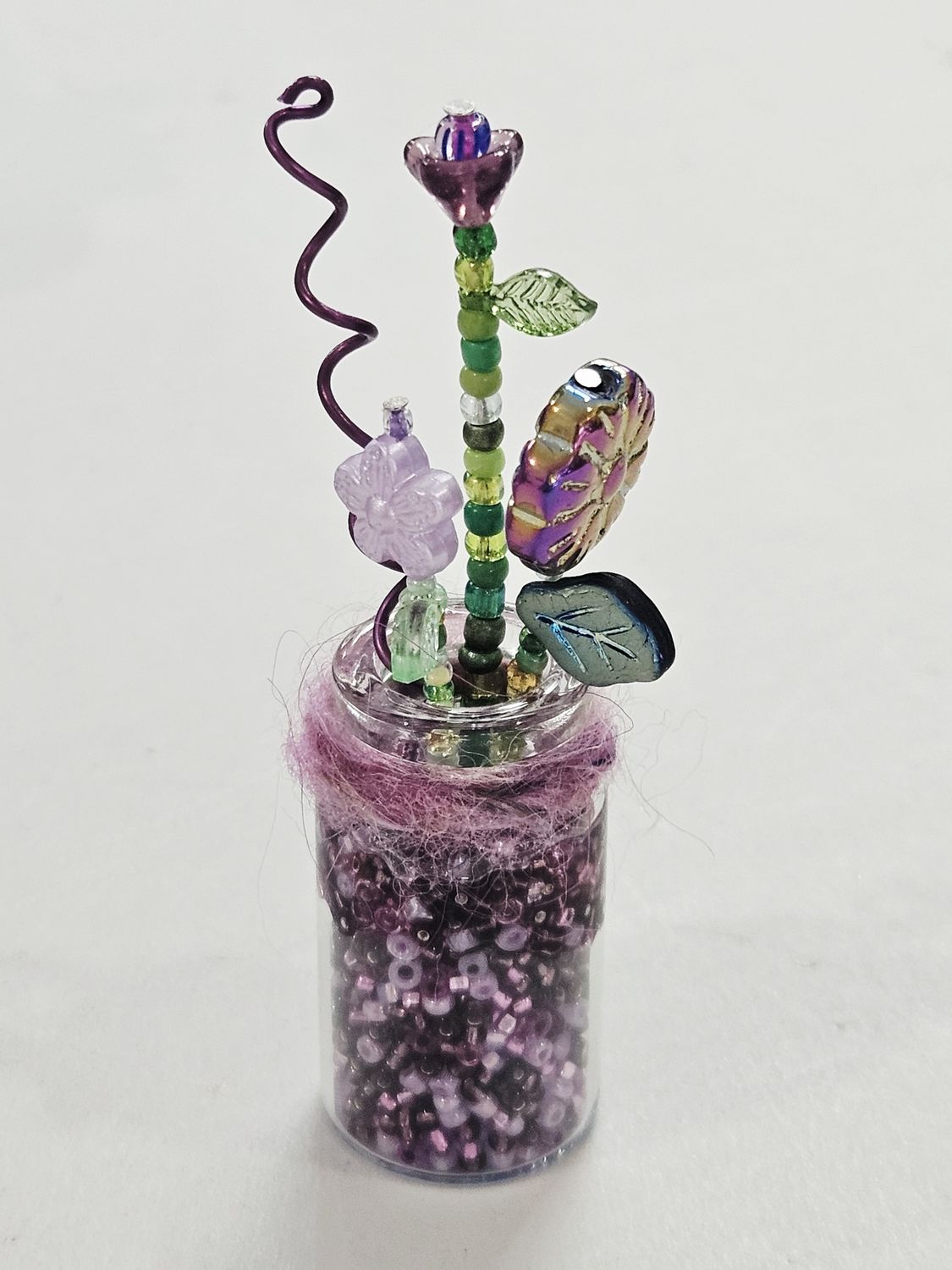 Purple Beaded flowers in clear vase