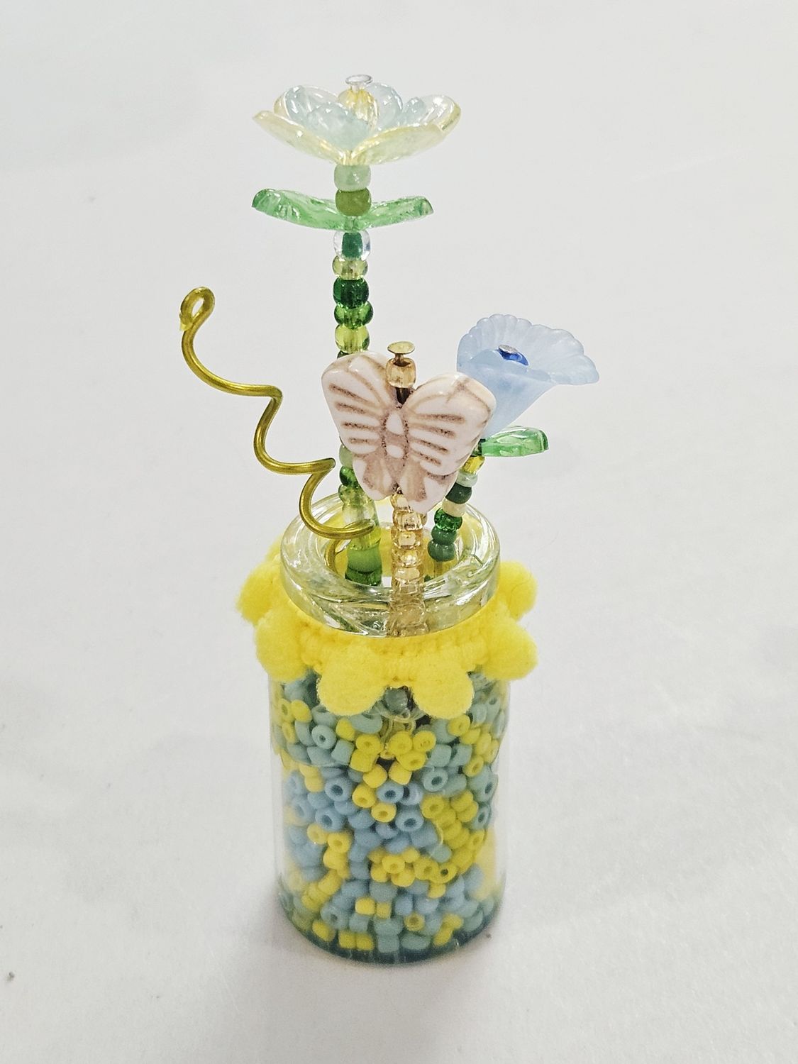 Blue and Yellow Beaded flowers in clear vase