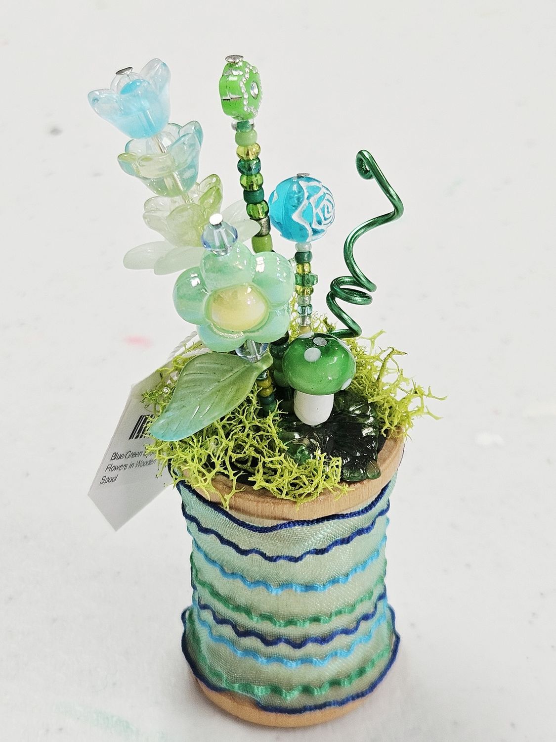 Blue/Green Beaded Flowers in Wooden Spool