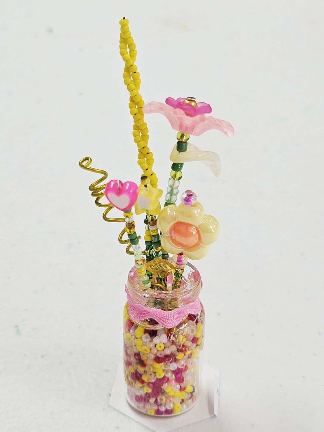 Pink/Yellow Beaded flowers in glass vase