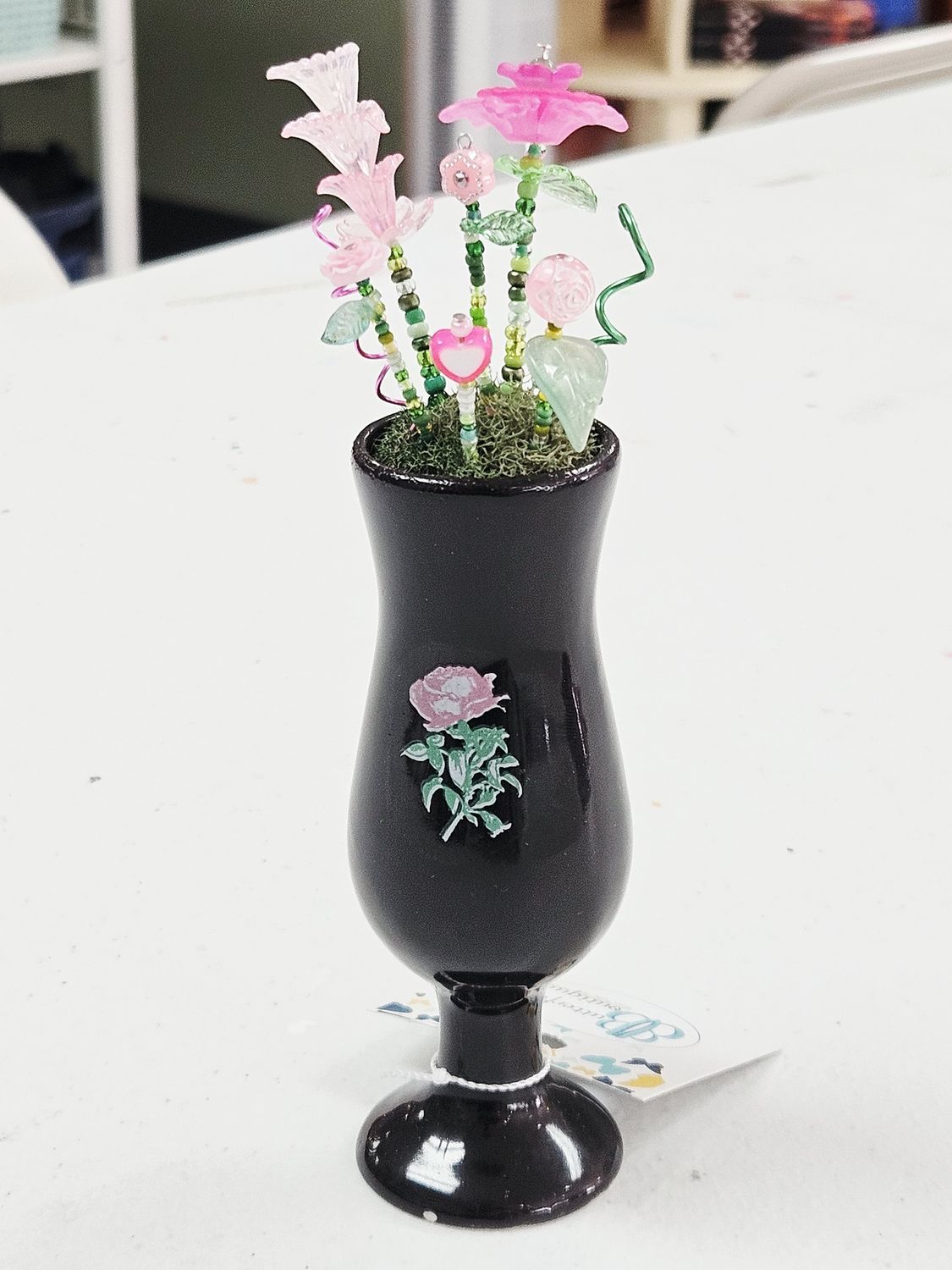 Black shot glass with pink beaded flowers