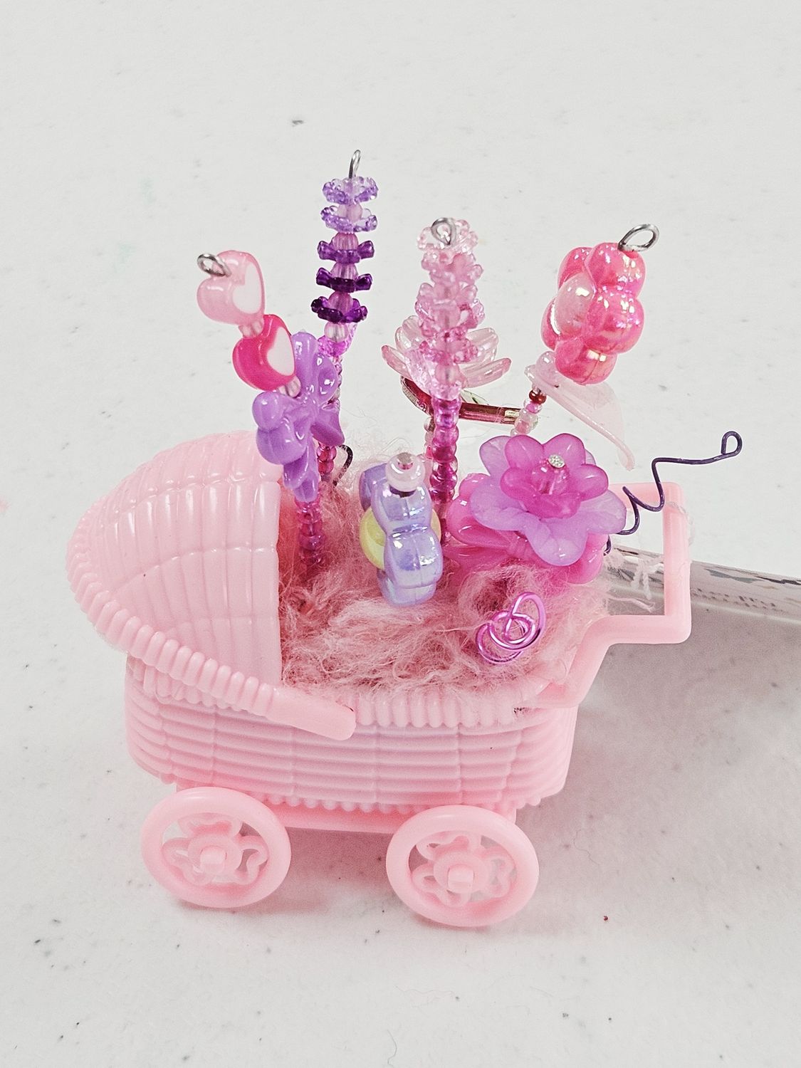 Pink baby buggy with beaded flowers