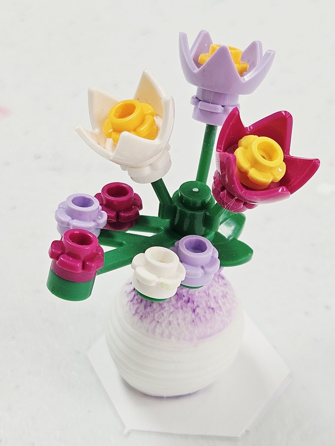 Purple, pink, white flowers in purple vase