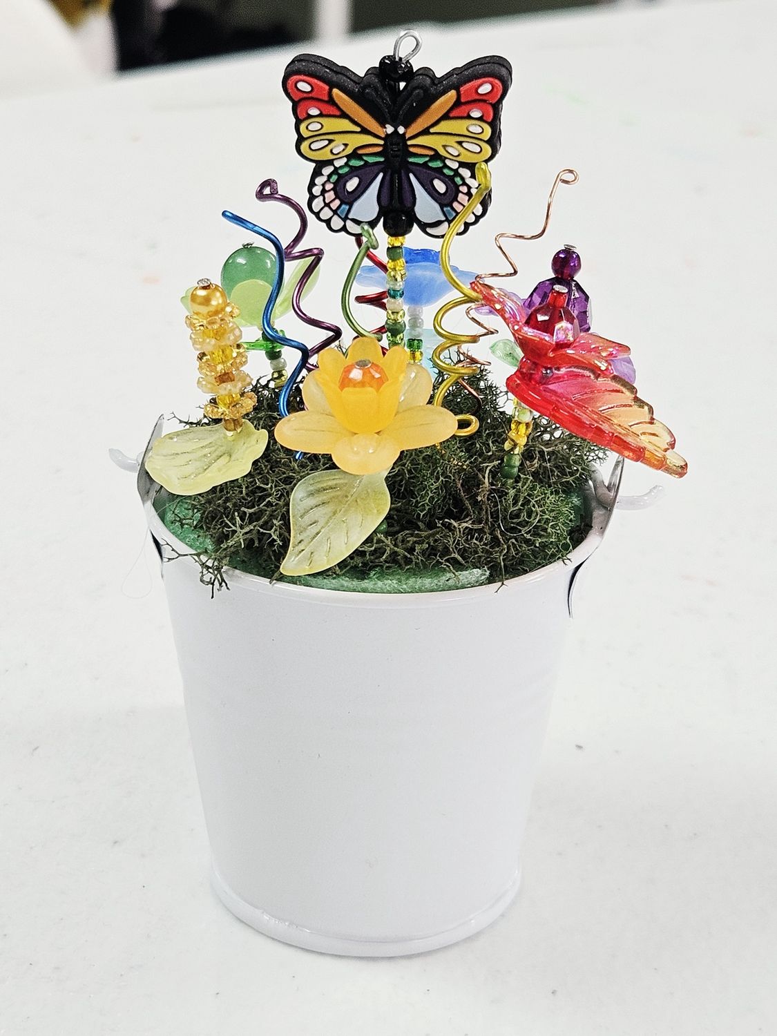 White pail with rainbow beaded flowers