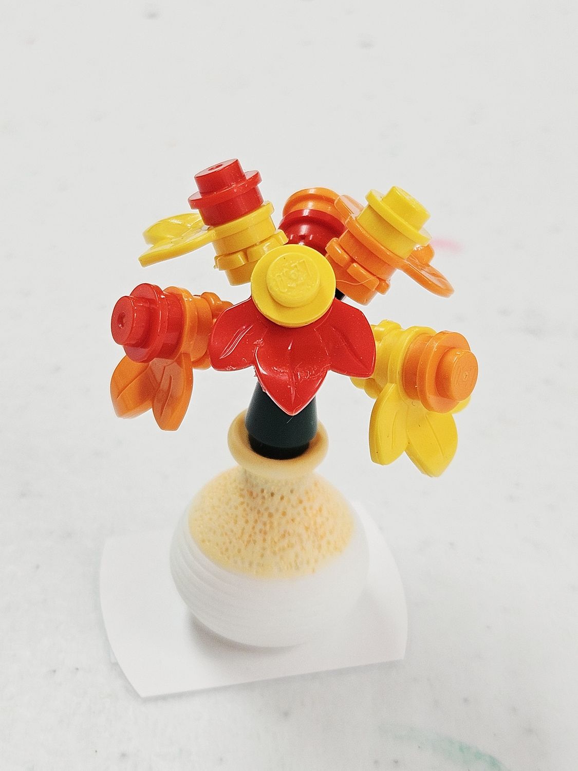 Red, Yellow, &amp; Orange flowers in yellow pot