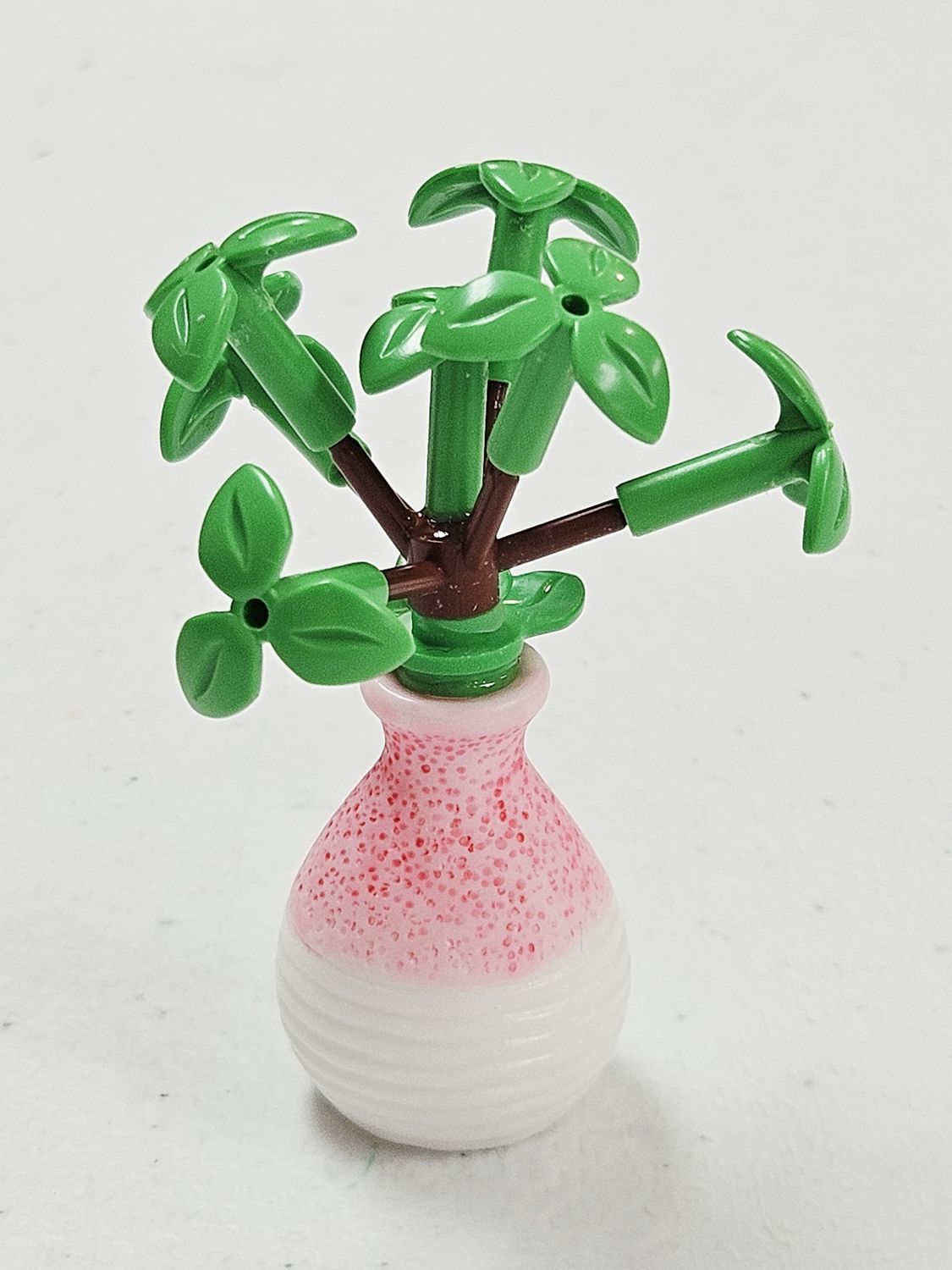 Green bush building block plant in pink vase