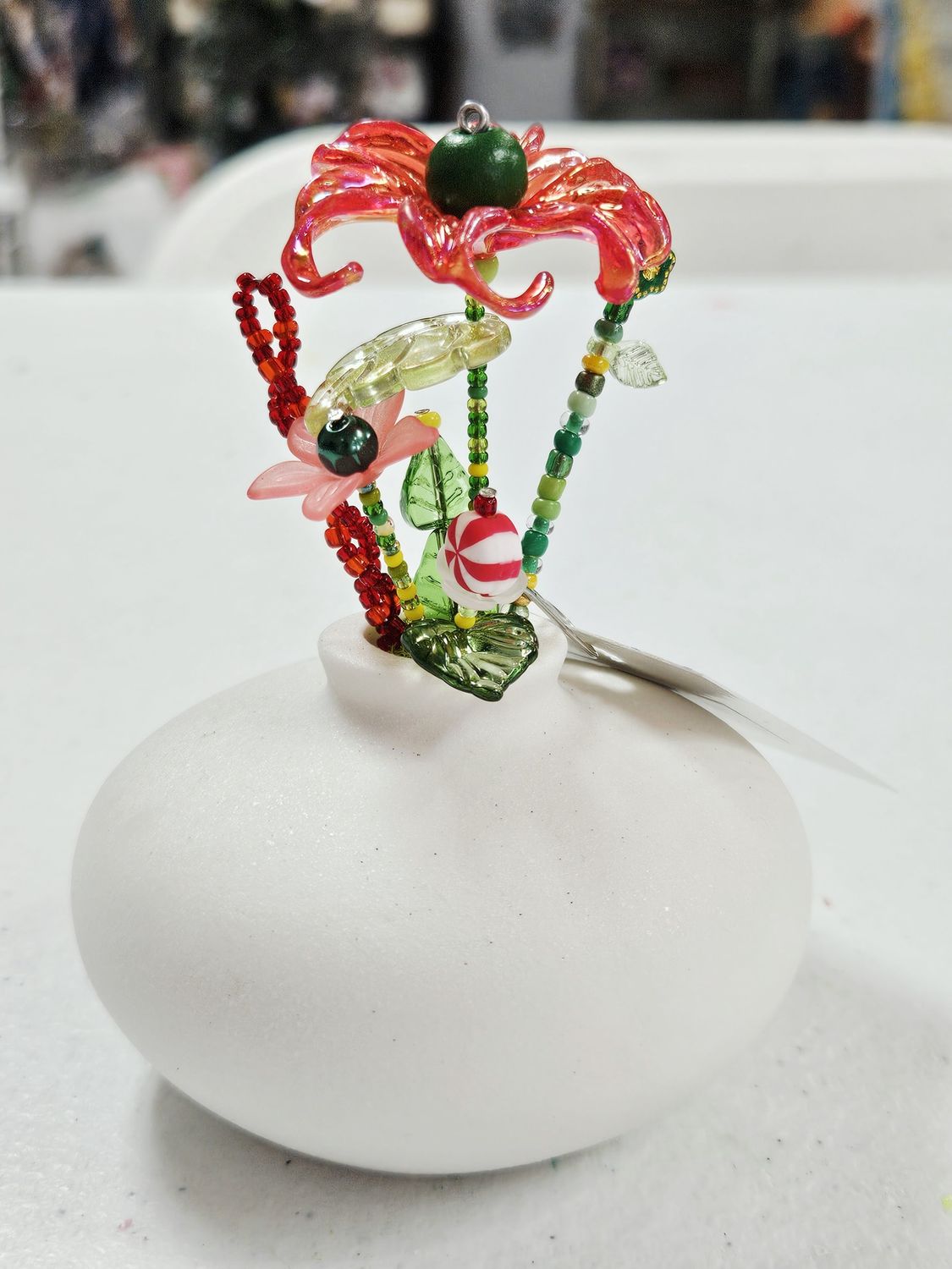 Red/Green Beaded Flowers in White Wide Vase