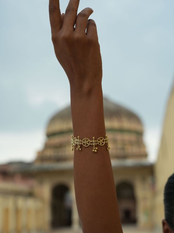model wearing christine bekaert jewelry handcrafted gold-plated mulmul bracelet with star design adjustable size