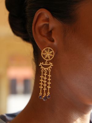 model wearing christine bekaert jewelry handcrafted gold-plated nabu earrings with star design and gemstones smokey quartz