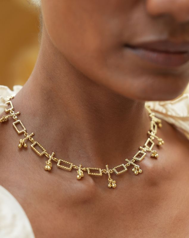 model wearing christine bekaert jewelry handcrafted gold-plated Nanna necklace with gold beads and adjustable size