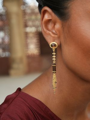 model wearing christine bekaert jewelry handcrafted gold-plated Hammurabi earrings with natural gemstones smokey quartz