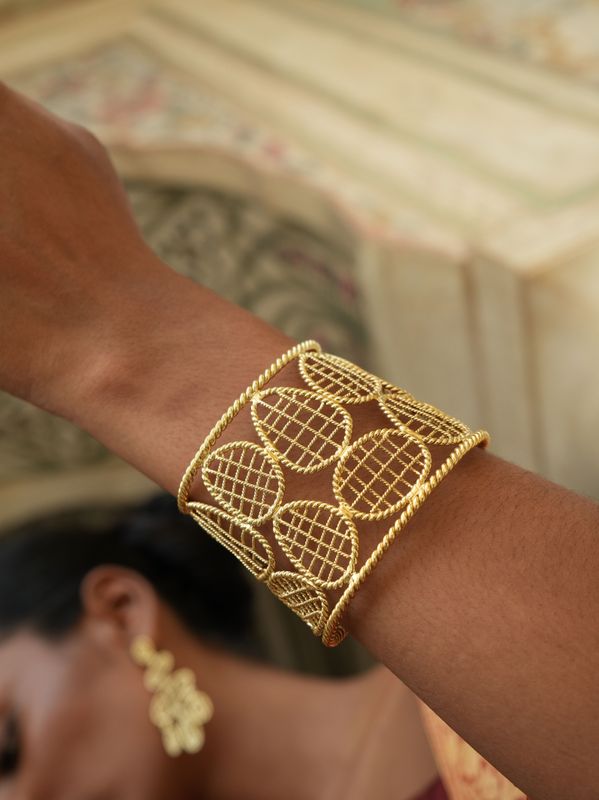 model wearing christine bekaert jewelry handcrafted gold-plated jalee statement cuff bracelet