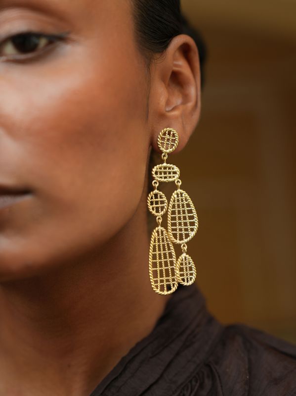model wearing christine bekaert jewelry handcrafted gold-plated statement dangle noori earrings