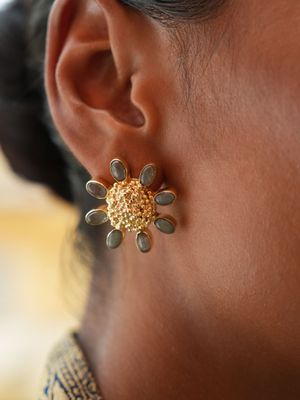 model wearing christine bekaert jewelry handcrafted gold-plated forever floret studs with natural gemstones labradorite