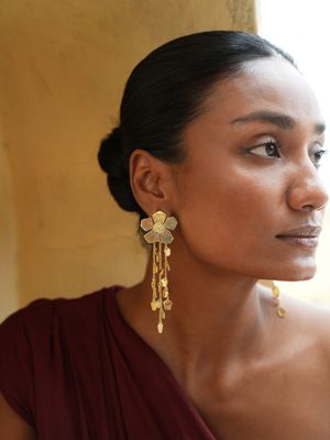 model wearing christine bekaert statement jewelry handcrafted gold-plated detachable eternelle dangle large earrings 