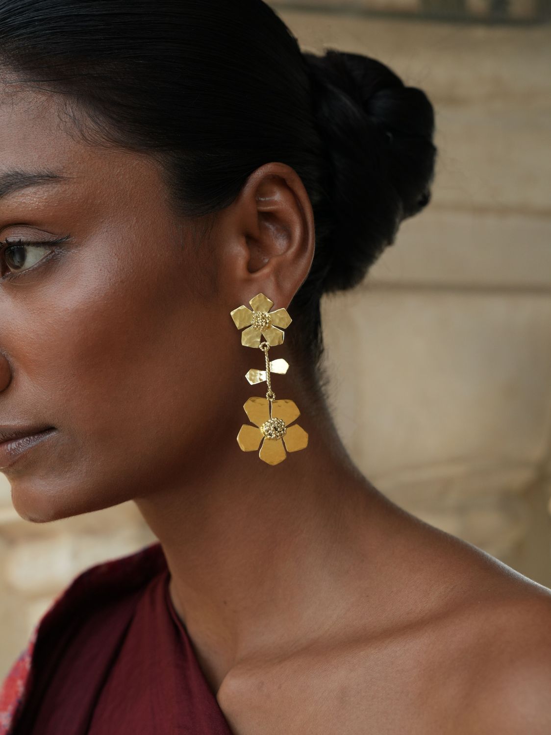 model wearing Christine Bekaert statement jewelry handcrafted gold-plated hand hammered eternelle duo earrings 