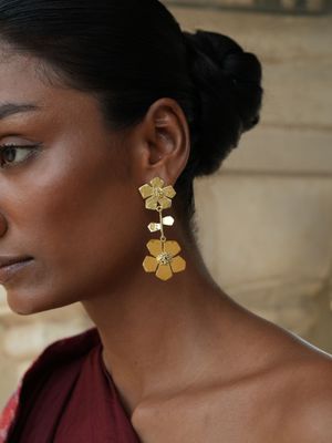 model wearing Christine Bekaert statement jewelry handcrafted gold-plated hand hammered eternelle duo earrings 