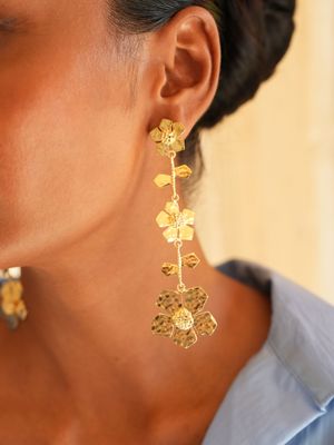 model wearing Christine Bekaert statement jewelry handcrafted gold-plated hand hammered eternelle fall earrings 