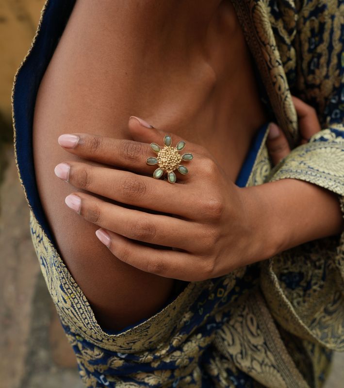 model wearing Christine Bekaert statement jewelry handcrafted gold-plated floret ring with labradorite and adjustable size