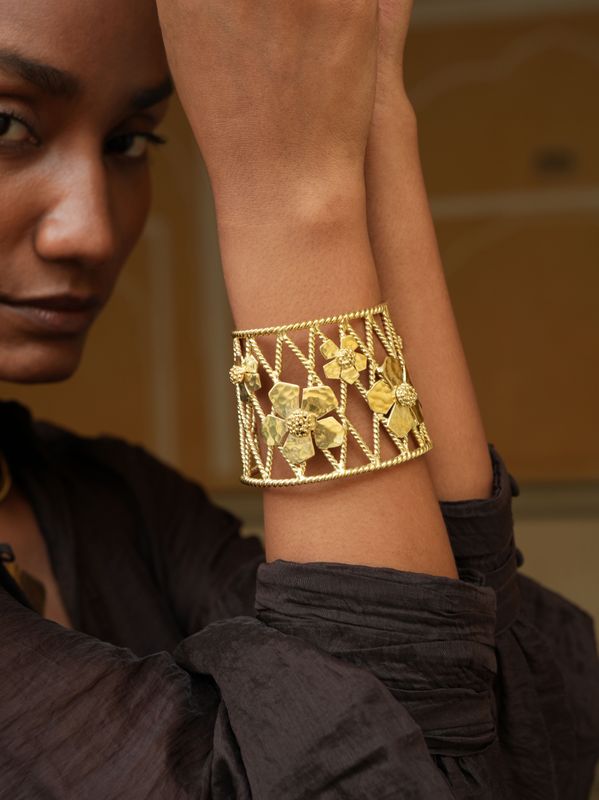 model wearing Christine Bekaert statement jewelry handcrafted gold-plated infinite garden cuff bracelet with adjustable size