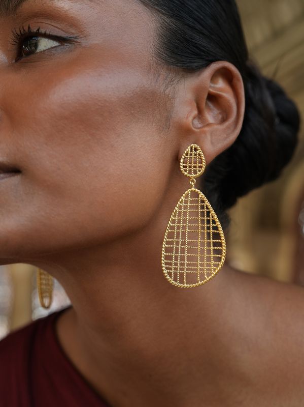 model wearing christine bekaert jewelry handcrafted gold-plated jalee large statement earrings