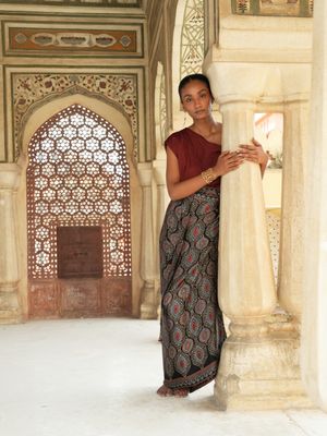 Model wearing statement wrap around skirt with black bagrou print designed by Christine Bekaert, unique piece in silk