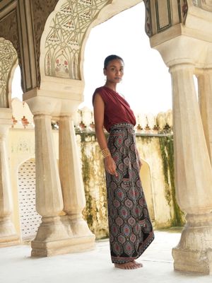 Model wearing statement wrap around skirt with black bagrou print designed by Christine Bekaert, unique piece in silk