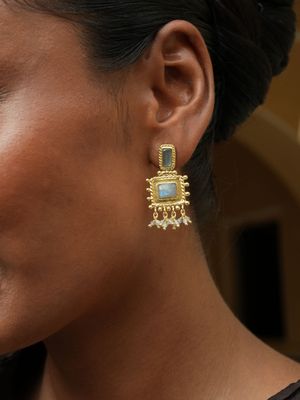 model wearing Christine Bekaert statement jewelry nisaba earrings handcrafted gold-plated with natural gemstones labradorite