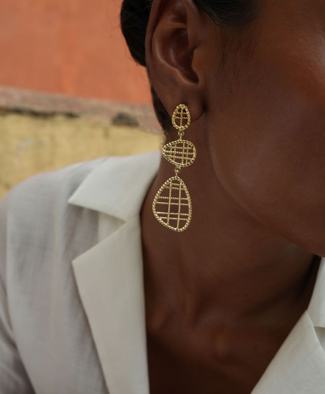 model wearing christine bekaert jewelry handcrafted gold-plated filli small statement earrings