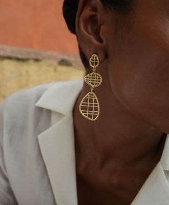 model wearing christine bekaert jewelry handcrafted gold-plated filli small statement earrings