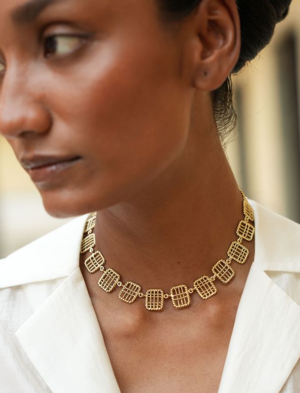 model wearing christine bekaert jewelry handcrafted gold-plated zenitha statement necklace with adjustable length