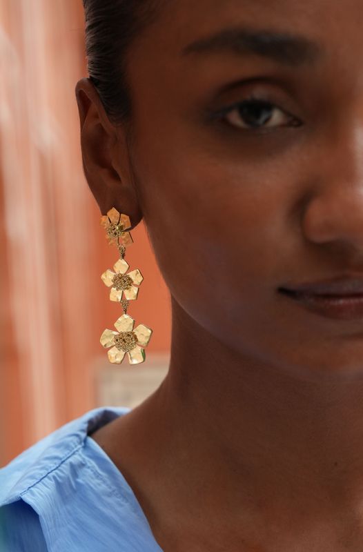 model wearing christine bekaert jewelry handcrafted gold-plated hammered statement everbloom fall earrings