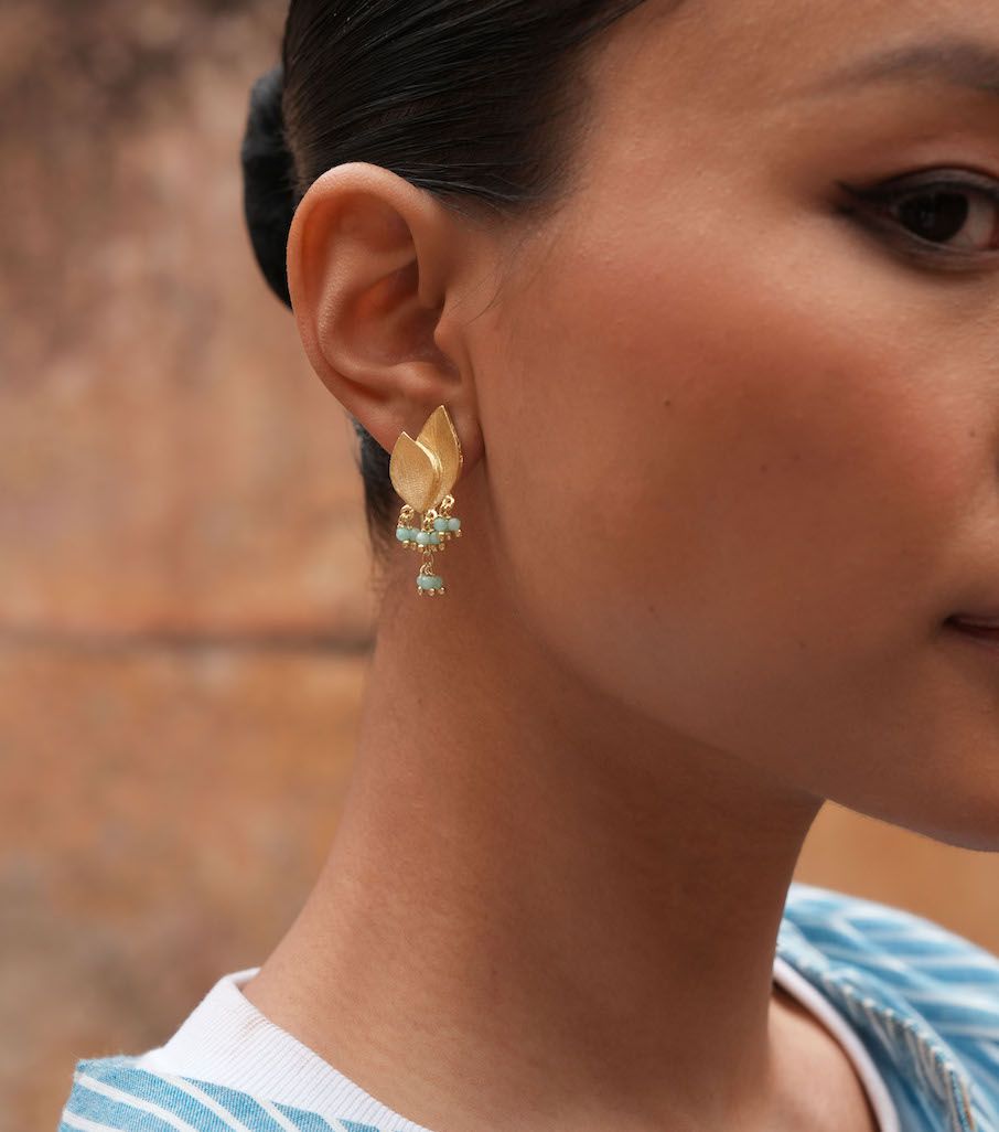 Product shot of small flower earrings with amazonite by Belgian Christine Bekaert handcrafted statement jewelry on model