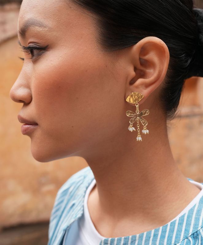 Product shot of small flower earrings with labradorite by Belgian Christine Bekaert handcrafted statement jewelry on model